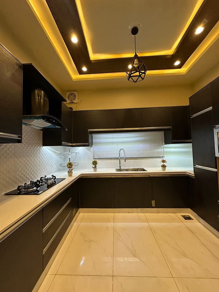 U-shaped executive modular kitchen with dark smoked veneer and ambient coves